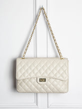 Quilted leather bag with gold details